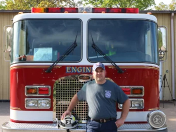 Man standing beside a fire truck