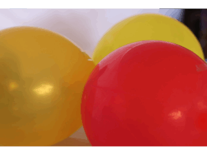 close up image of three shiny balloons one red one yellow and one gold