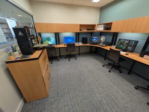 Digital media center with four computer stations and a 3D printer.