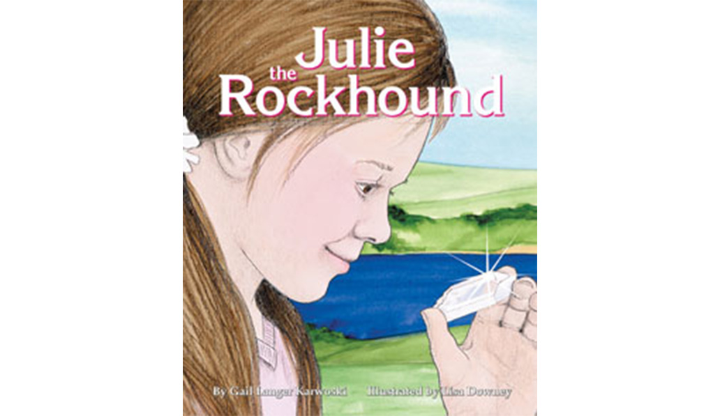 Bookcover of "Julie the Rockhound" by Gail Langer Karwoski, Illustrated by Lisa Downey. Art of girl looking at shiny crystal.